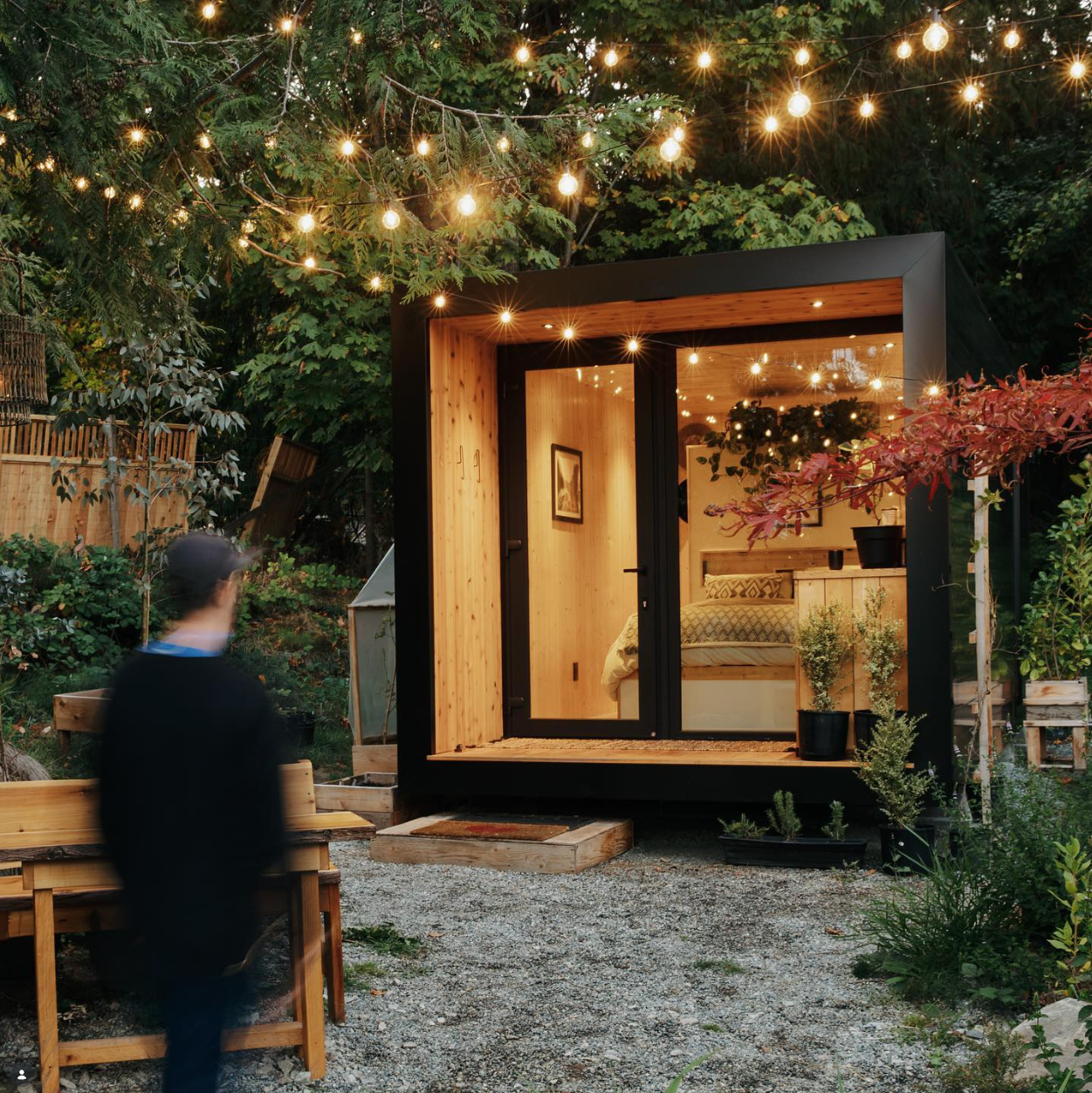 An aux box at dusk with string lights — the result of the process