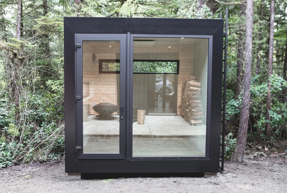 Model 106 modular studio exterior in a forested backyard